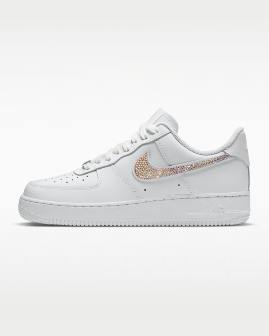 White sneaker with rose gold swoosh logo on a white background